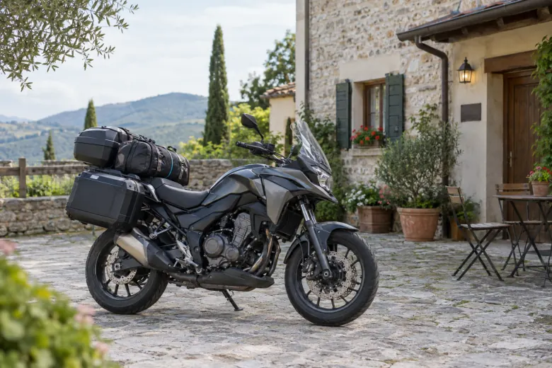 Touring motorcycle with luggage parked outside a stone building