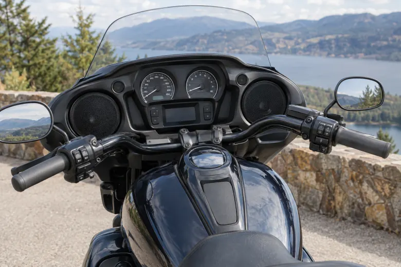 Speakers integrated into the cockpit of a parked touring motorcycle